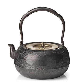 A large cast iron tea pot with cover, Japan, Meiji period (1868-1912). Interior of cover with signature.