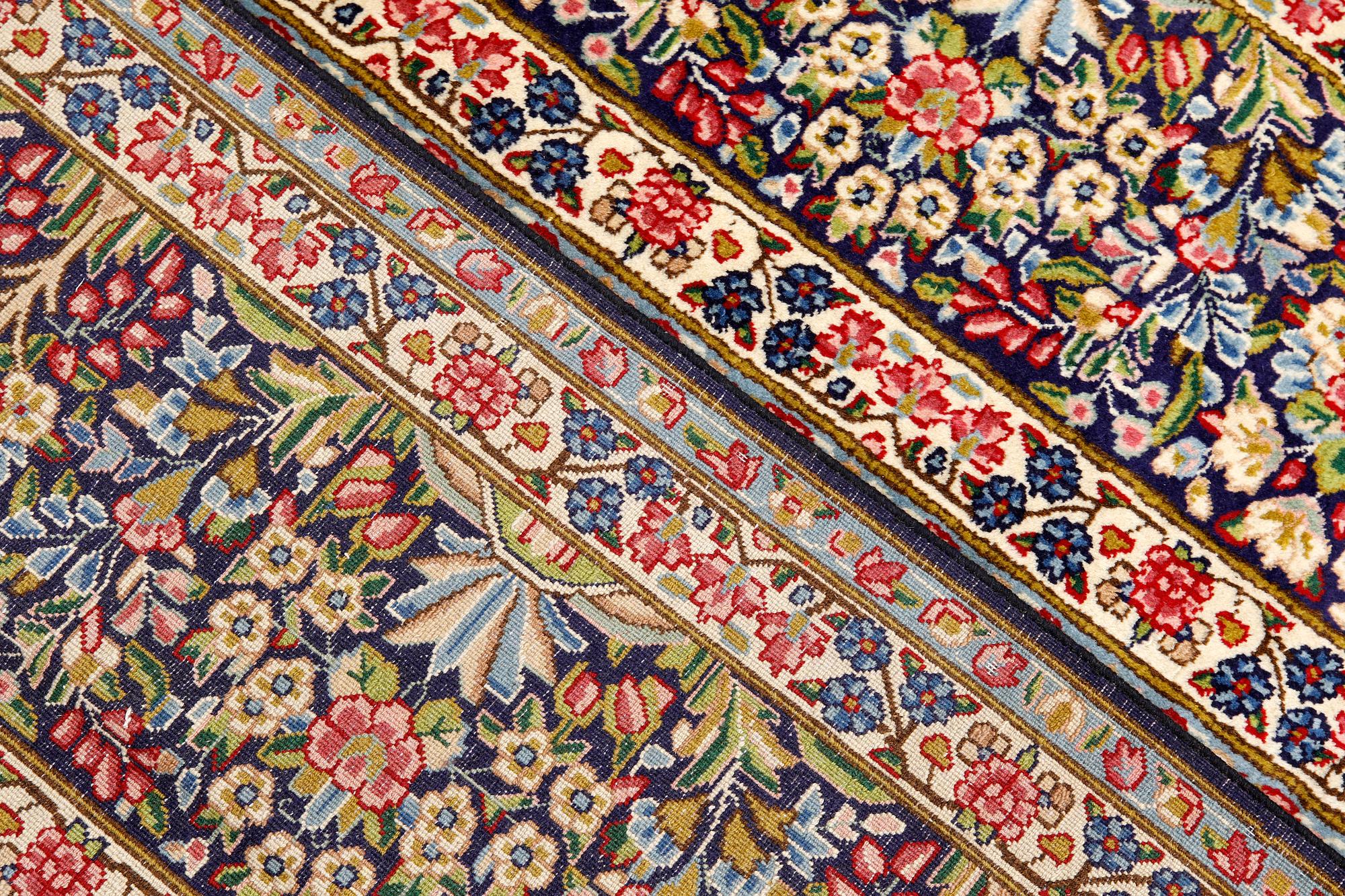 A Kirman Laver carpet, 'Millefleur', approx. 400 x 295 cm.