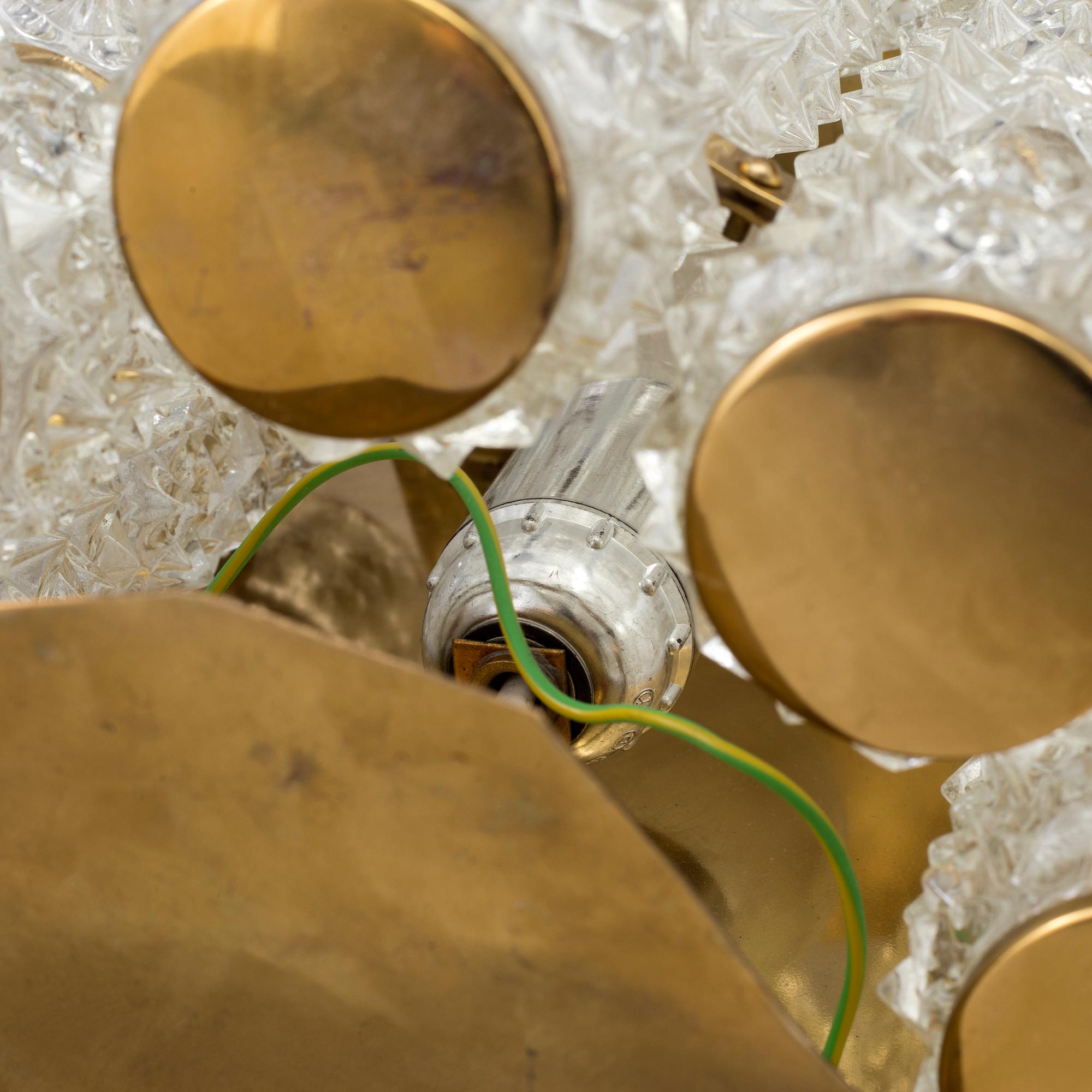 A pair of 1970's glass and brass wall lamps.