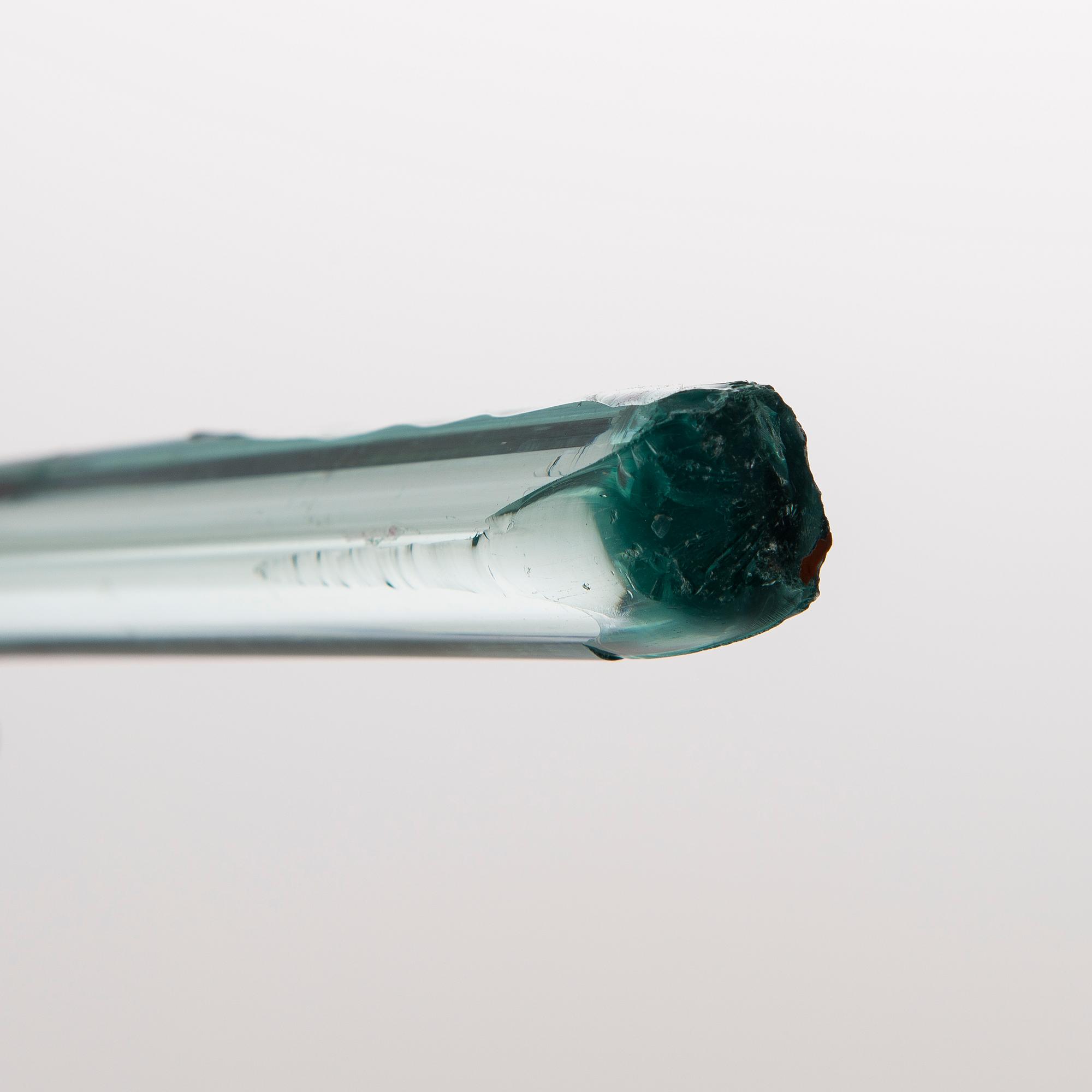 A greenish glass walking stick.