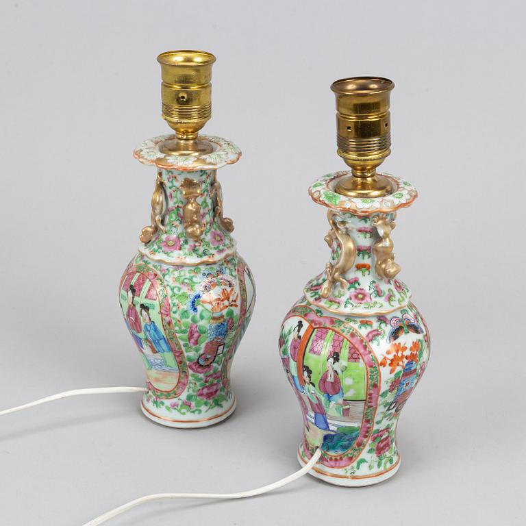 A pair of famille rose Canton table lamps and a vase, Qing dynasty, 19th Century.