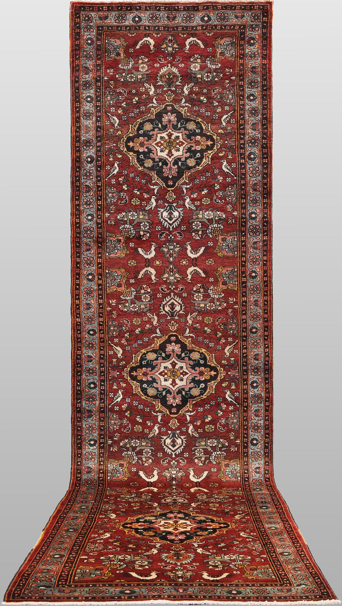 A figural Hamadan runner carpet, 450 x 112 cm.