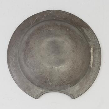 A 18th century pewter shaving bowl.