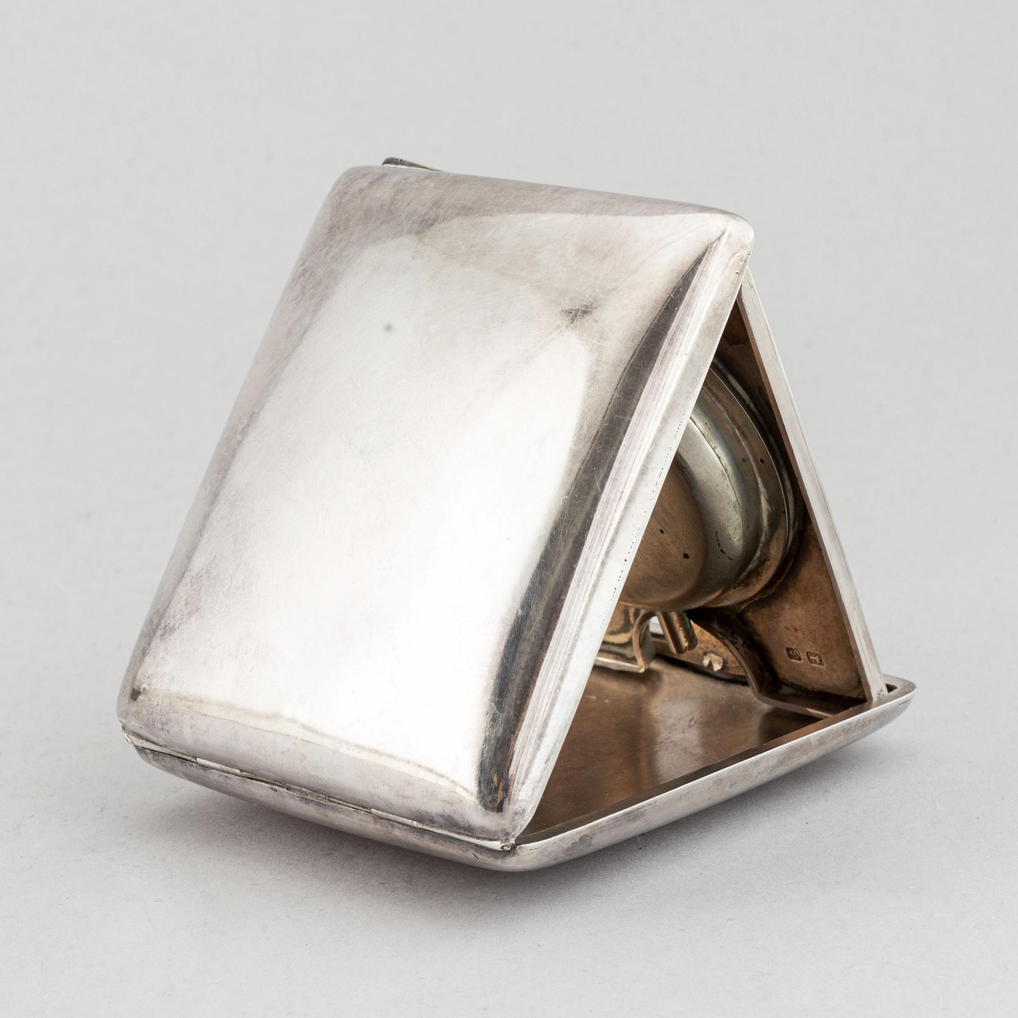 A silver travel alarm clock, makr of Hasset & Harper Ltd, Birmingham 1921.