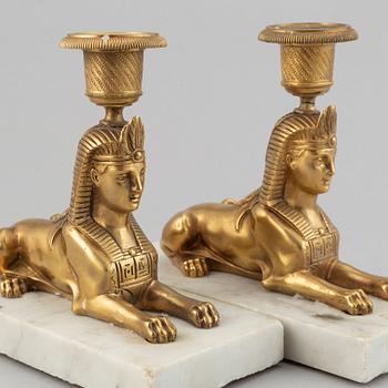 A pair of empire style 19th century candlesticks.