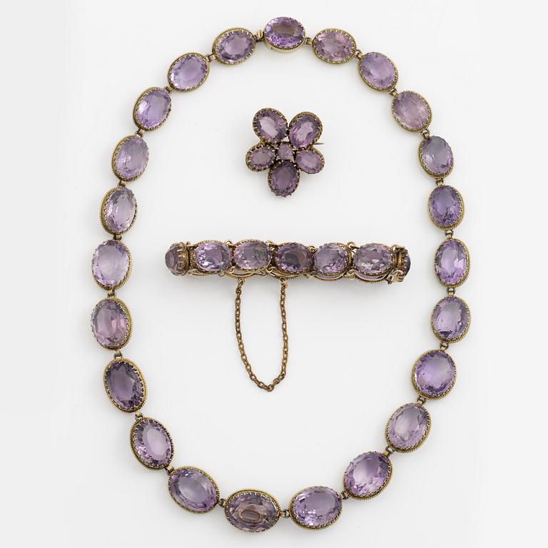 Garniture, necklace and bracelet silver with amethysts, brooch gold-coloured metal with purple paste stones,