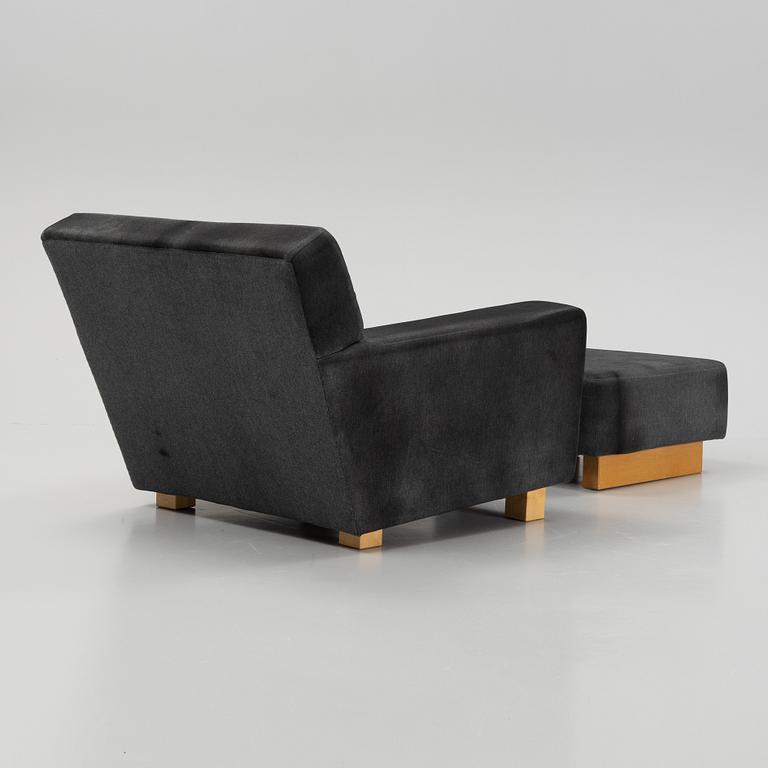 A model 3665 lounge chair with stool by Björn Trägårdh for Firma Svenskt Tenn.