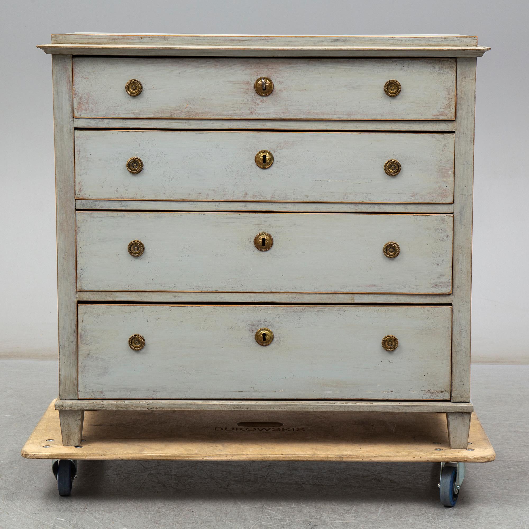 a chest of drawers from the first half of the 19th century.