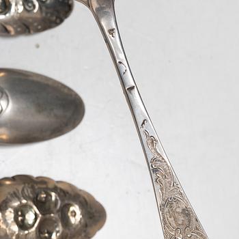 Seven silver spoons, including English and Swedish hallmarks.