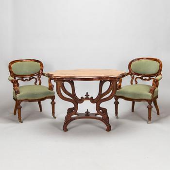 A pair of Russian armchairs and a table, late 19th century.