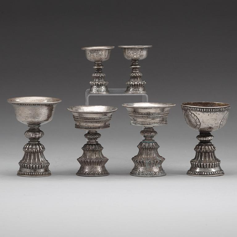 A group of six Tibetan silver/silvered Butter lamps, 19th Century.