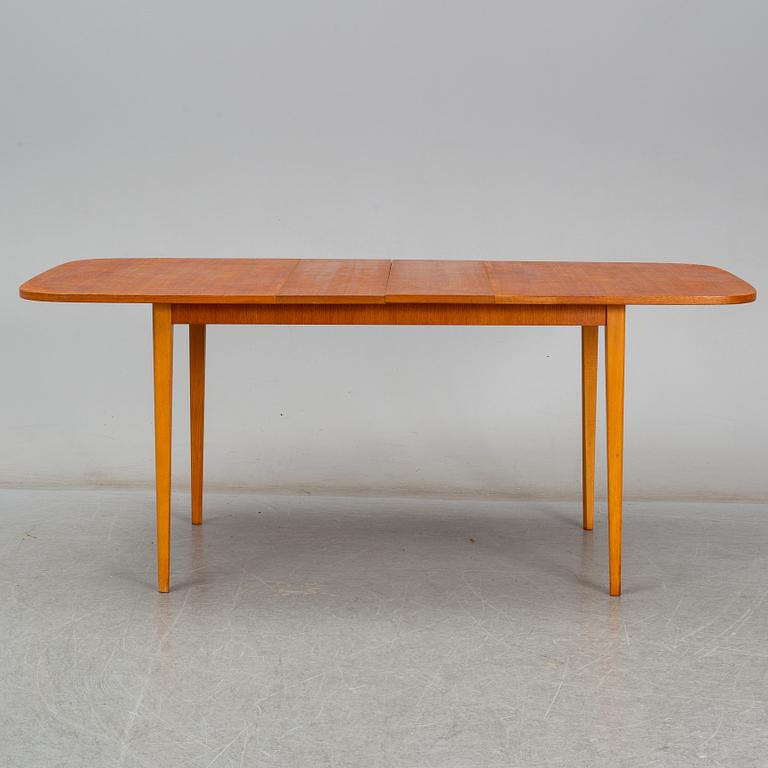 A second half of the 20th century teak veneered dining table.