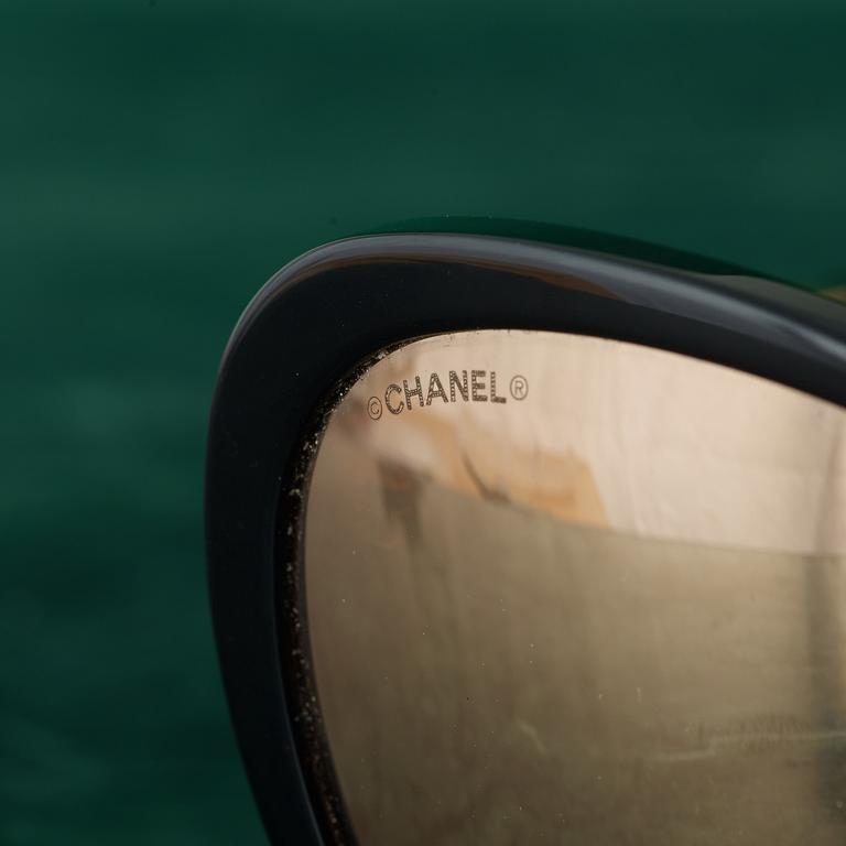 A pair of SUNGLASSES by CHANEL.