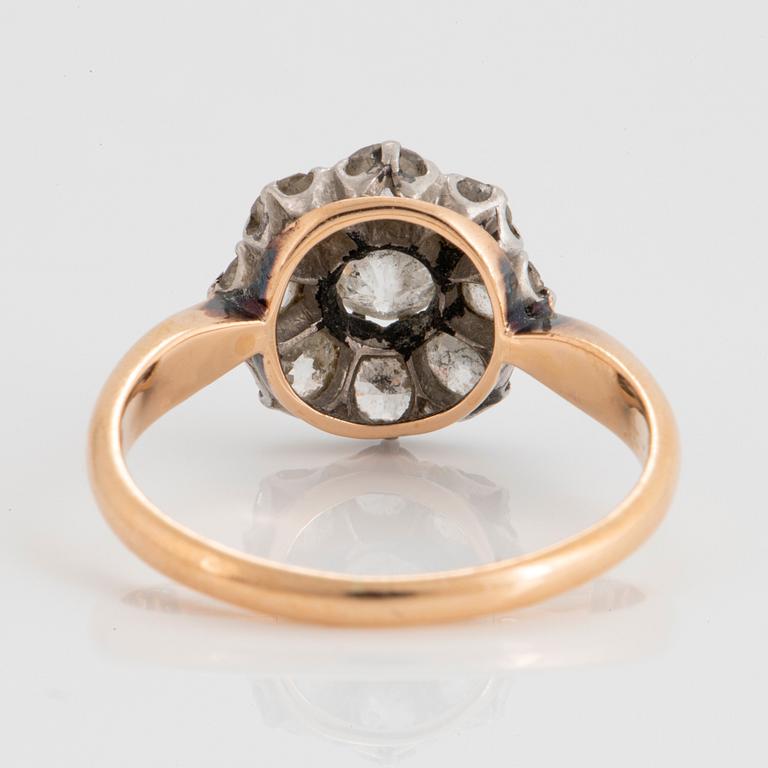 An 18K gold ring set with old-cut diamonds.