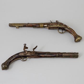 Two 19th century flintlock pistols.