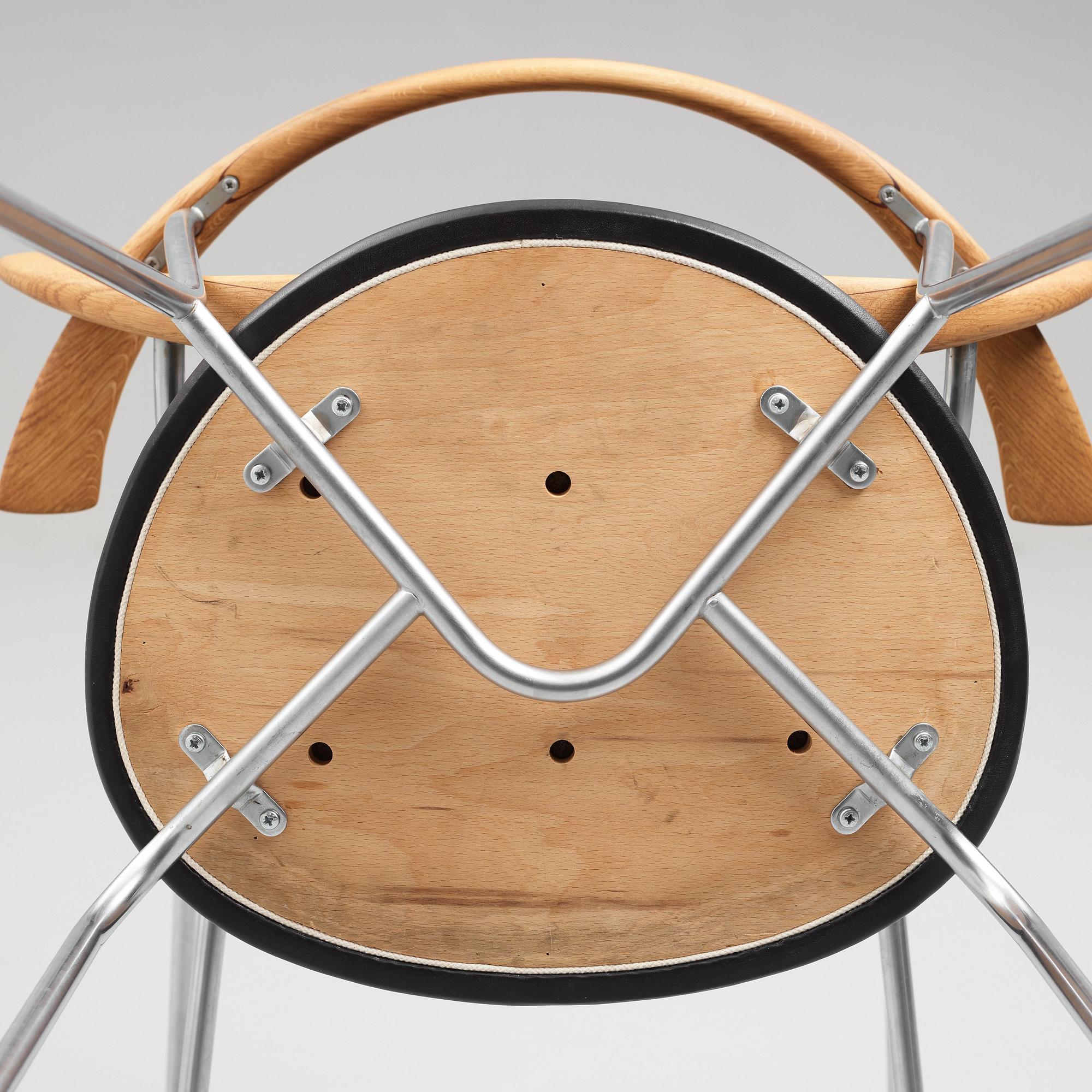 Hans J. Wegner, a set of six "JH-701" oak and black leather chairs by Johannes Hansen, Denmark.
