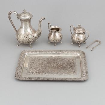 A Pakistan silver coffee pot, sugar bowl, sugar tongs and creamer.