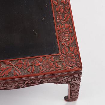 A carved lacquered table, early 20th Century.