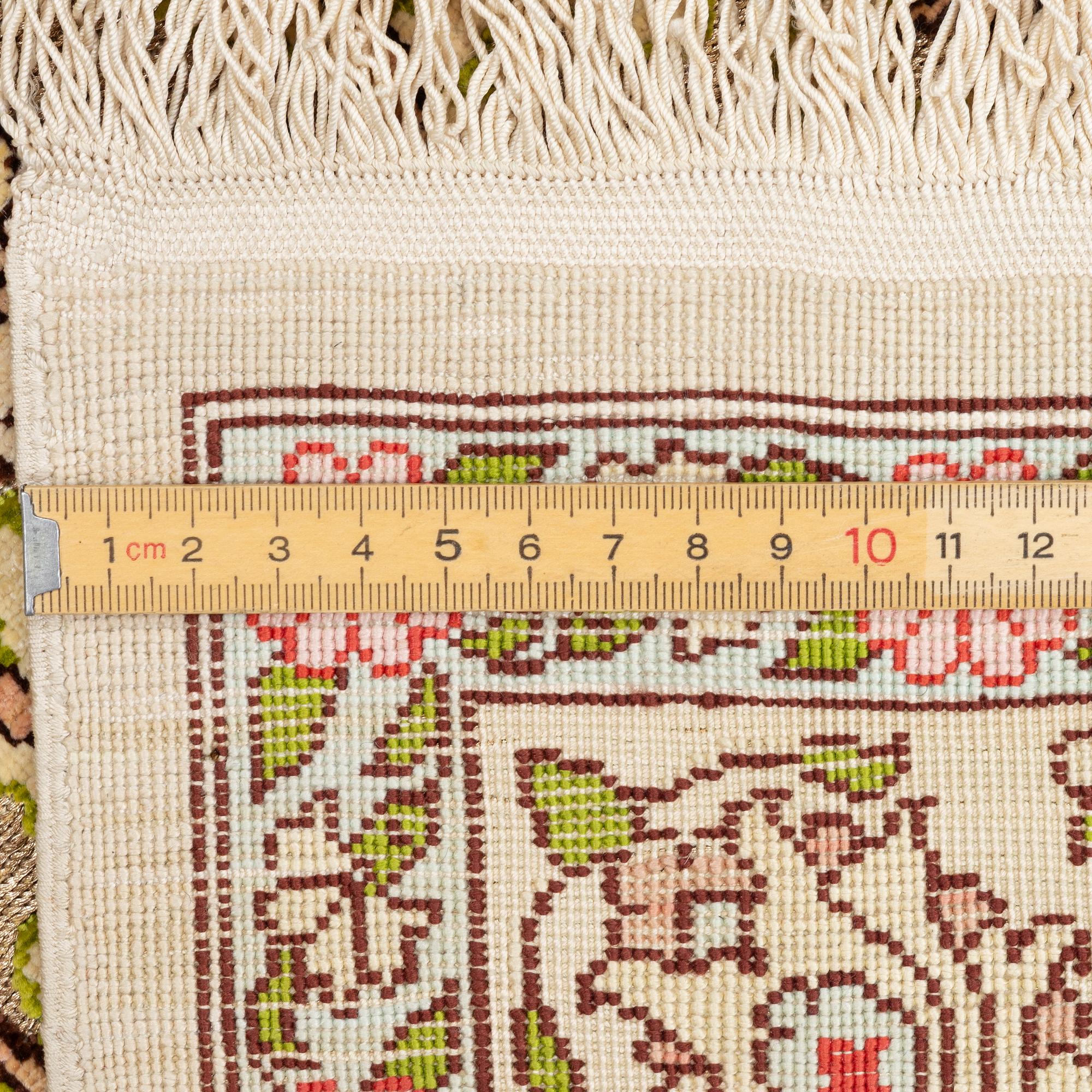 A silk an metal Hereke rug, West Anatolia, c. 100 x 68 cm.