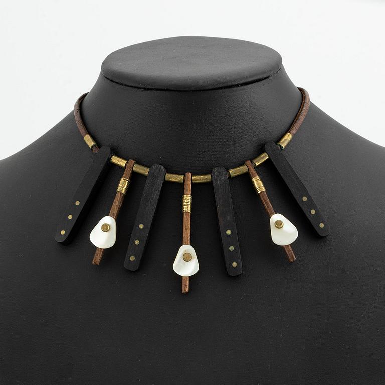 Vivianna Torun Bülow-Hübe, a necklace, wood, leather, mother-of-pearl and brass, most likely 1950's.