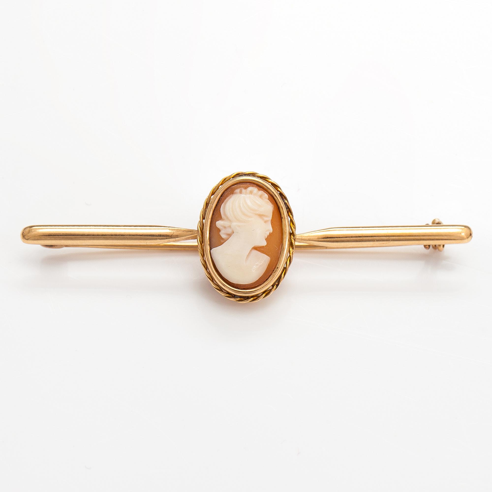 Two brooches and a ring, 14K and 18K gold and sea shell cameos.