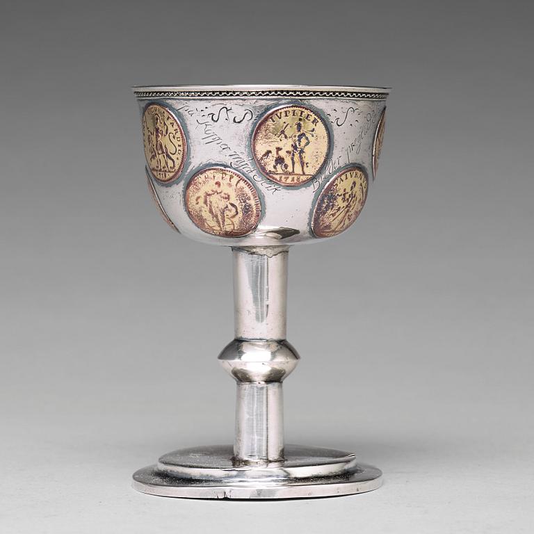 A Swedish 18th century parcel-gilt silver tumbler / cup, with copper coins, unmarked.