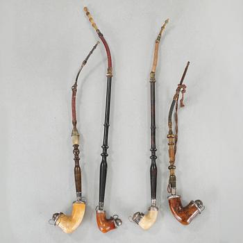 A 19th century pipe-rack with ten pipes and accessories.