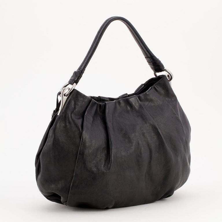 PRADA, a black leather shoulder bag.