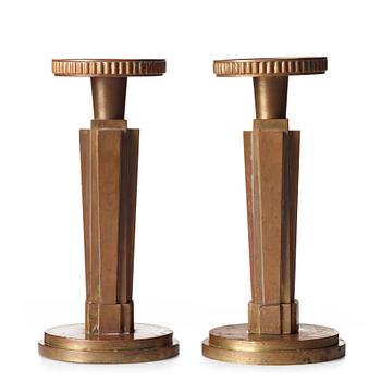 265. Lars Holmström, a pair of Swedish Grace patinated bronze candlesticks, Arvika, Sweden, 1920's-30's.