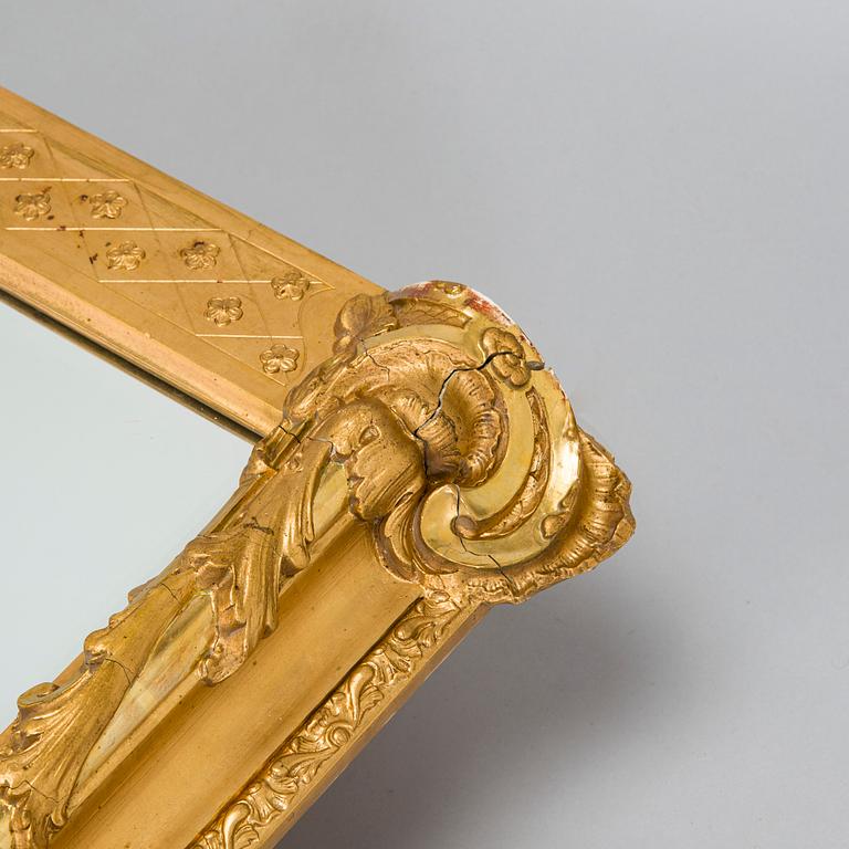 A Rococo Revival style mirror, circa 1900.