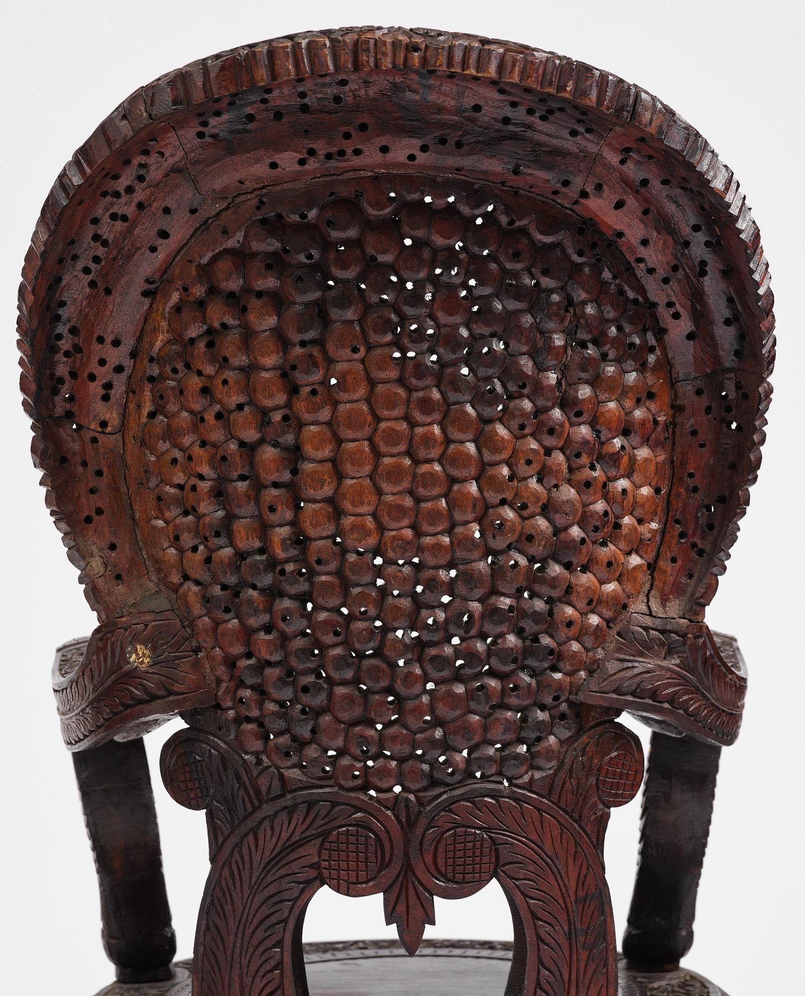 A pair of carved 'blackwood' armchairs, Bombay presidency, British Raj, circa 1880.
