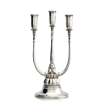 514. Georg Jensen, a sterling silver three-light candelabrum, designed by Harald Nilesen, model no 595, Copenhagen, 1925-1932.