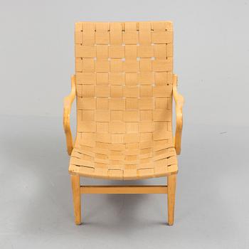 an "Eva" armchair by BRUNO MATHSSON 1963.