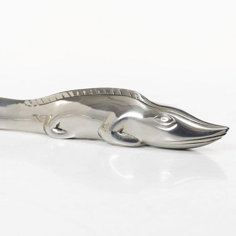 Firma Svenskt Tenn, Candelabrum, 'Vänskapsknuten', and paper knife, 'Alligator'.
