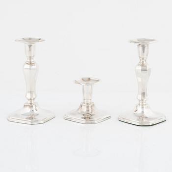 A pair of silver candlesticks, MGAB, Uppsala, 1985 and a silver candlestick, MEMA, Lidköping, 1987.