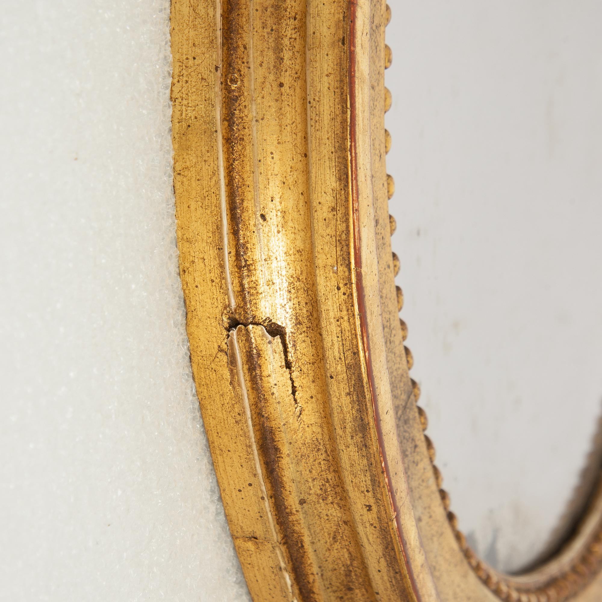 A pair of one-light Gustavian-style giltwood girandole mirrors, late 18th c /resp circa 1900.