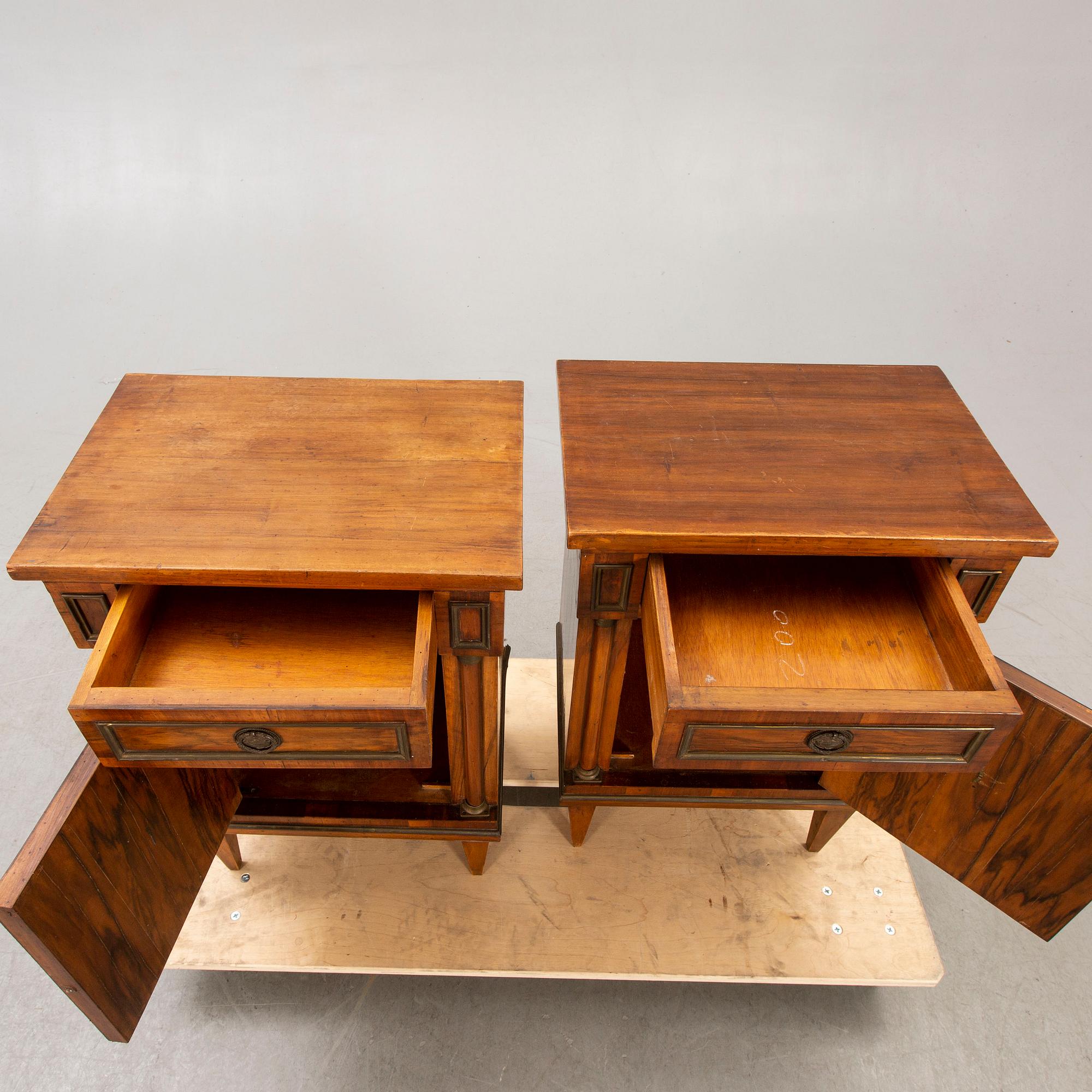 A pair of walnut Empire style bedside tables first half of the 20th century.