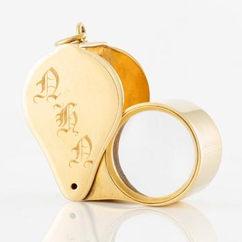 A loupe in 18K gold.