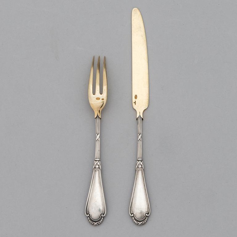 A set of Fabergé parcel-gilt silver dessert cutlery, 11 pieces + one fork later manufactured by Kultakeskus, Finland.