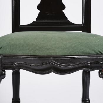 A set of eight black Swedish rococo chairs.