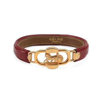 CÉLINE, a winered leather bracelet.