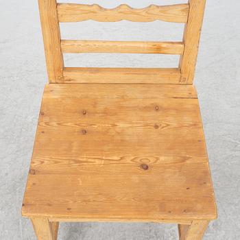 A gateleg table eith 6 + 6 chairs.