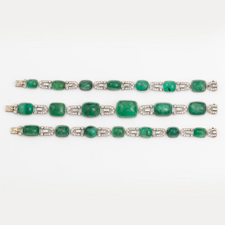 An art deco platinum necklace/bracelet combination with cabochon-cut emeralds.