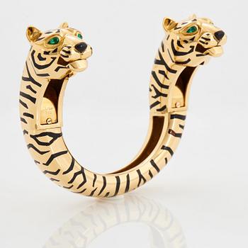 Cartier "Panthère" an 18K gold and enamel bracelet set with emeralds.