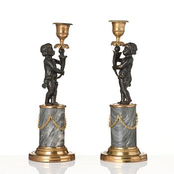 A pair of French Louis XVI ormolu and marble candlesticks, late 18th century.