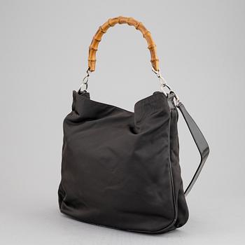 Gucci, a chocolate brown nylon handbag.