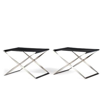 61. Poul Kjaerholm, a pair of black leather and steel "PK-91" folding stools, edition Fritz Hansen, Denmark.