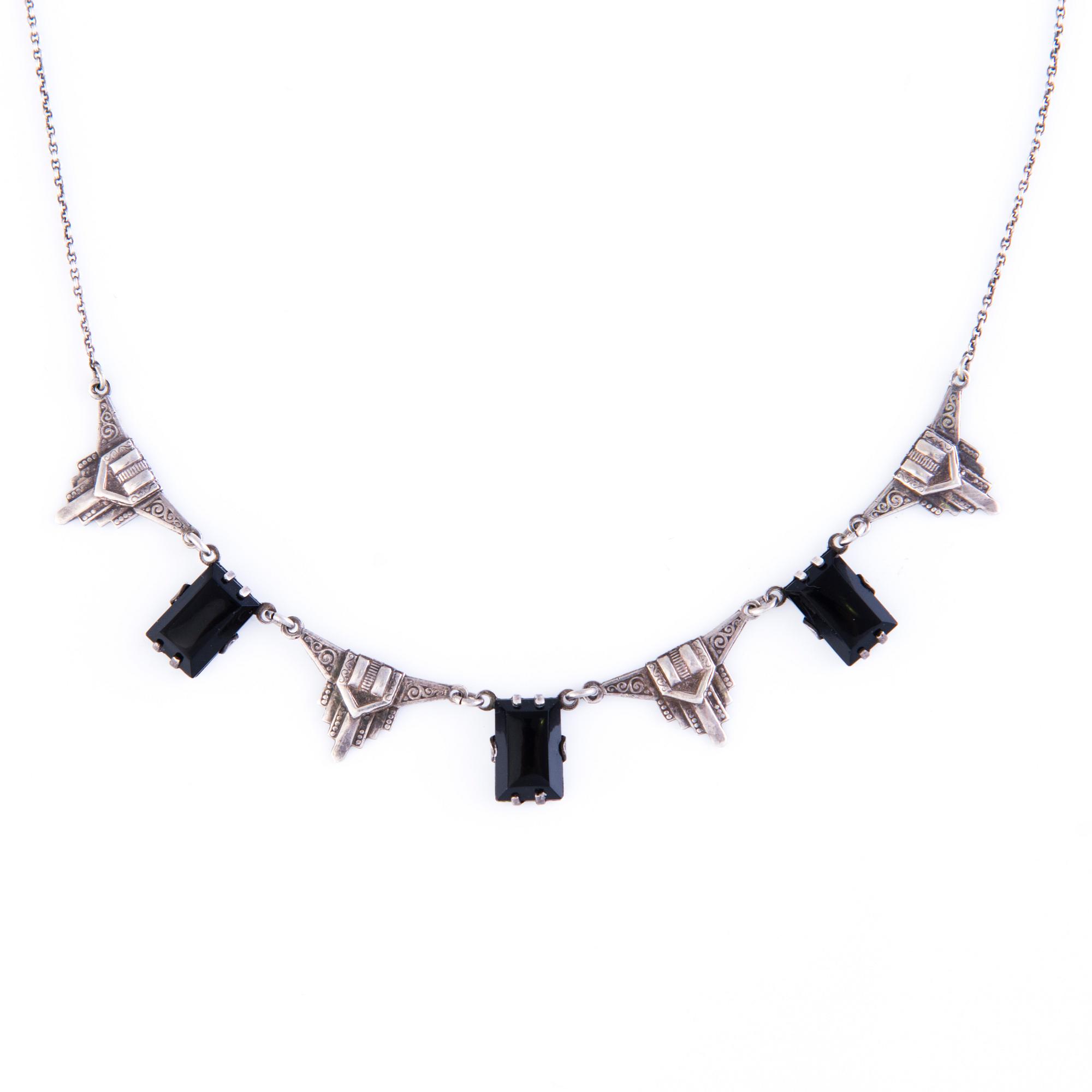 Four Art deco jewelry, ring, pendant necklace and earrings in silver.