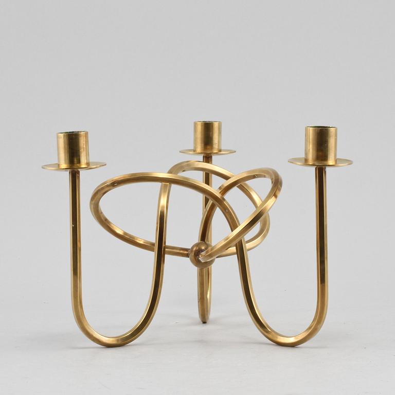 LJUSSTAKE, mässing, "Vänskapsknuten", Josef Frank, Firma Svenskt Tenn, 1900-talets andra hälft.