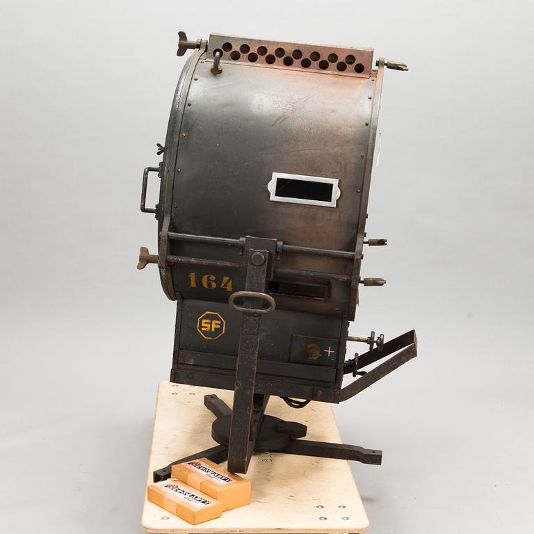 A film industry carbon arc spotlight with two boxes Kino-carbon sticks, + and -.